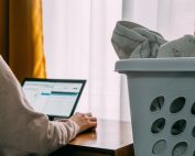 Laundry basket by woman on computer looking for a job, Platinum Resumes, Kansas City, MO