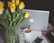 Laptop by vase of yellow tulips, Platinum Resumes, Kansas City, MO