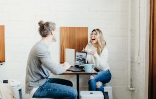 2 girls across from one another on laptops drinking coffee, Platinum Resumes, Kansas City, MO