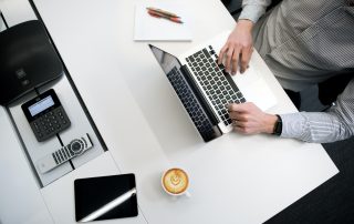 Man on laptoop with coffee, Platinum Resumes, Kansas City, MO