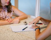 2 women tralking over a resume, Platinum Resumes, Kansas City, MO