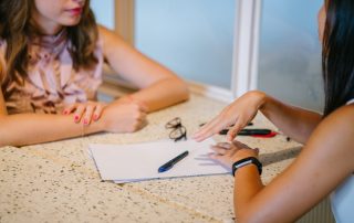 2 women tralking over a resume, Platinum Resumes, Kansas City, MO