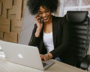 Woman laughing at her laptop, Platinum Resumes, Kansas City, MO