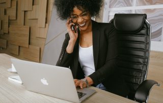 Woman laughing at her laptop, Platinum Resumes, Kansas City, MO