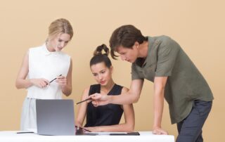 3 young people gathered around a laptop, Platinum Resumes, Kansas City, MO