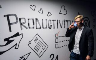 Man in front of white board that says productive, Platinum Resumes, Kansas City, MO