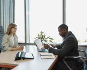 2 people at a desk interviewing, Man taking notes talking to man with name tag, Platinum Resumes, Kansas City, MO