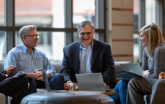 a group of executives discussing their careers and resumes with a professional resume writer in kansas city.